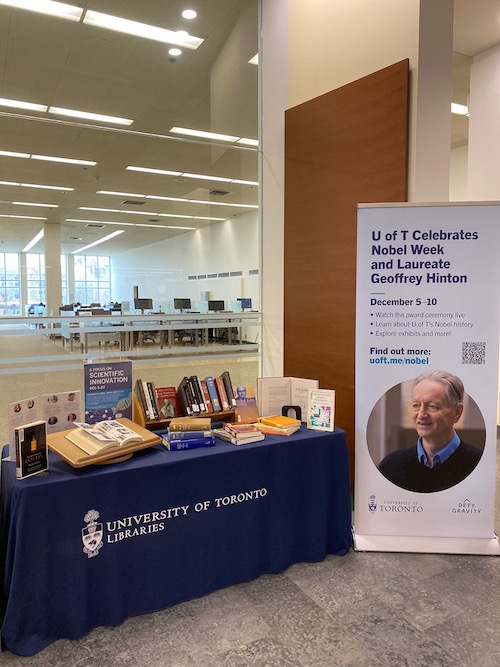 display of books on a table next to large banner about Nobel Week