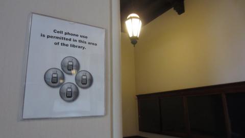 Sign indicating cell phone use is permitted in this area of the library