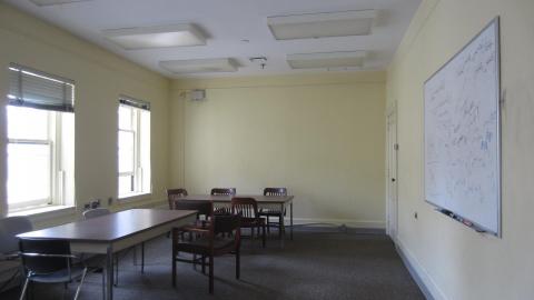 Image of Room 1230 showing window, tables, and whiteboard